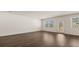 Spacious living room with hardwood floors, a window, and a glass door, offering ample natural light at 8590 Secretariat Dr, Lithonia, GA 30058