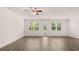 Expansive living room with ceiling fan, abundant light and neutral decor at 8590 Secretariat Dr, Lithonia, GA 30058