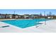 Community pool with bright blue water and depth markers, surrounded by a white concrete deck and black metal fence at 8590 Secretariat Dr, Lithonia, GA 30058