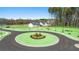 New homes in Champions Run are nestled among green landscaping, tall trees and a circular street at 8590 Secretariat Dr, Lithonia, GA 30058