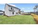 View of the home's backyard with new sod and a covered patio area at 6096 Marigold Way, Atlanta, GA 30349