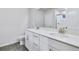 Bathroom with double vanity, framed mirror, tile floor, and shower at 6096 Marigold Way, Atlanta, GA 30349