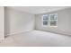 A carpeted bedroom space bathed in natural light from two bright windows at 6096 Marigold Way, Atlanta, GA 30349