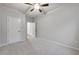 Comfortable carpeted bedroom with a ceiling fan and two doors at 6096 Marigold Way, Atlanta, GA 30349