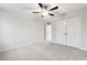 A bedroom features neutral walls, carpeted flooring, and a ceiling fan at 6096 Marigold Way, Atlanta, GA 30349