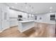 Modern kitchen with white cabinets, quartz countertops, stainless steel appliances, and island with pendant lighting at 6096 Marigold Way, Atlanta, GA 30349