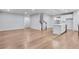 Open-concept living area, hardwood flooring, staircase with dark wood railing and white balusters and recessed lighting at 6096 Marigold Way, Atlanta, GA 30349