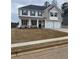 Two-story home features a brick and siding facade, dark shutters, a two-car garage and manicured lawn at 738 Great Oak Pl, Villa Rica, GA 30180