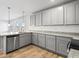 Elegant kitchen features stainless steel appliances, gray cabinets, and a functional island with breakfast bar at 738 Great Oak Pl, Villa Rica, GA 30180