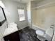Bright bathroom featuring a shower-tub combination, a window, and a modern vanity at 1004 Hamilton Dr, Locust Grove, GA 30248