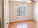 Bright bedroom with hardwood floors, a ceiling fan, and a large window at 1004 Hamilton Dr, Locust Grove, GA 30248