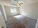 Bedroom featuring a ceiling fan, a window, and carpeted floors at 1004 Hamilton Dr, Locust Grove, GA 30248