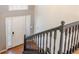 Bright foyer featuring a white front door with sidelights, staircase, and hardwood flooring at 1004 Hamilton Dr, Locust Grove, GA 30248