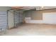 Garage featuring concrete flooring and a gray garage door at 1004 Hamilton Dr, Locust Grove, GA 30248