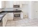 Kitchen featuring stainless steel appliances, white cabinets, and a tiled floor at 1004 Hamilton Dr, Locust Grove, GA 30248