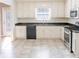 Well-lit kitchen with white cabinets, stainless steel appliances, and dark countertops at 1004 Hamilton Dr, Locust Grove, GA 30248