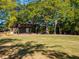 Outdoor amphitheater boasts a spacious stage and sprawling lawn seating, perfect for community events and performances at 203 Hubbard Rd, Woodstock, GA 30188