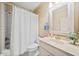 Cozy bathroom showcasing a shower with white subway tile and a neutral vanity with decorative mirror at 203 Hubbard Rd, Woodstock, GA 30188