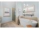 Serene bathroom featuring a freestanding tub, glass shower, and stylish fixtures at 203 Hubbard Rd, Woodstock, GA 30188