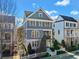 Charming three-story home with a welcoming front porch, beautiful landscaping, and a white picket fence at 203 Hubbard Rd, Woodstock, GA 30188