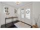 Bright foyer showcases textured double doors, decorative table, and dark wood floors at 203 Hubbard Rd, Woodstock, GA 30188