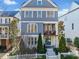 Charming two-story home boasting a welcoming porch, gray siding, and lush landscaping at 203 Hubbard Rd, Woodstock, GA 30188