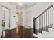 Hallway view featuring hardwood floors, stairs with iron railings, and neutral paint scheme at 203 Hubbard Rd, Woodstock, GA 30188