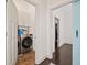 View of laundry room and hallway with barn door to closet, plus luxury washer and dryer at 203 Hubbard Rd, Woodstock, GA 30188