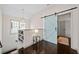 Hallway features barn door, open staircase, dark wood floors, and lots of natural light at 203 Hubbard Rd, Woodstock, GA 30188