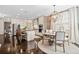Open-concept kitchen with stainless steel appliances, a large island, and a dining area with an elegant chandelier at 203 Hubbard Rd, Woodstock, GA 30188