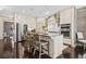Bright kitchen featuring stainless steel appliances, barstool seating at the island and hardwood floors at 203 Hubbard Rd, Woodstock, GA 30188