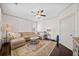 Comfortable living room showcasing a sectional sofa and a stylish ceiling fan at 203 Hubbard Rd, Woodstock, GA 30188