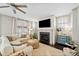 Inviting living room with fireplace, large windows, and neutral furniture, offering a cozy atmosphere at 203 Hubbard Rd, Woodstock, GA 30188