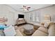 Comfortable living room featuring a neutral color palette, ceiling fan, and ample natural light from the windows at 203 Hubbard Rd, Woodstock, GA 30188