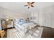 Sunlit main bedroom featuring a decorative dresser, plush bedding, and ample space at 203 Hubbard Rd, Woodstock, GA 30188