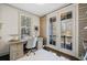 Bright office featuring French doors to balcony, wood accent wall, neutral decor, and natural light at 203 Hubbard Rd, Woodstock, GA 30188