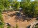 Aerial view of a well-equipped playground with climbing structures, a tunnel, and a wooden bridge surrounded by mature trees at 203 Hubbard Rd, Woodstock, GA 30188