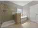 Bathroom featuring a soaking tub and glass shower at 5253 Rosewood Pl, Fairburn, GA 30213