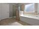 Bathroom featuring a soaking tub and glass shower at 5253 Rosewood Pl, Fairburn, GA 30213