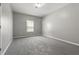 Carpeted bedroom with a window and neutral paint at 5253 Rosewood Pl, Fairburn, GA 30213