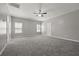 Generously sized bedroom with wall-to-wall carpeting and multiple windows at 5253 Rosewood Pl, Fairburn, GA 30213