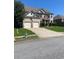 Two-story brick home with a well-manicured lawn and a two-car garage at 5253 Rosewood Pl, Fairburn, GA 30213