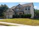 A charming two-story home with a brick facade, well-maintained lawn, and beautiful curb appeal at 5253 Rosewood Pl, Fairburn, GA 30213