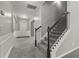Bright foyer featuring staircase with black handrails, carpeted steps, and neutral wall color at 5253 Rosewood Pl, Fairburn, GA 30213