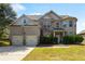 Traditional brick home with an attached two-car garage, manicured lawn, and mature shrubbery at 5253 Rosewood Pl, Fairburn, GA 30213