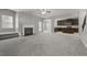 Spacious living room featuring a fireplace and an open layout to the kitchen at 5253 Rosewood Pl, Fairburn, GA 30213