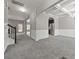 Spacious living room with archways, coffered ceiling, gray carpet, and traditional white wainscoting at 5253 Rosewood Pl, Fairburn, GA 30213