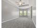 Spacious main bedroom with a tray ceiling, ceiling fan, and windows at 5253 Rosewood Pl, Fairburn, GA 30213