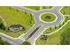 An aerial view reveals a meticulously landscaped roundabout surrounded by freshly paved streets, trees, and sidewalks at 8603 Secretariat Dr, Lithonia, GA 30058