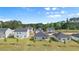 Aerial view of new homes with gray siding and green lawns, set against a backdrop of lush trees at 8603 Secretariat Dr, Lithonia, GA 30058